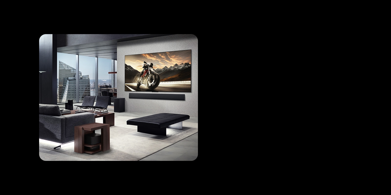 LG OLED M4 and LG Soundbar mounted on the living room wall of a high-rise apartment. The layout is clutter-free. The Zero Coonect Box can be seen, hidden underneath a side table by a couch.