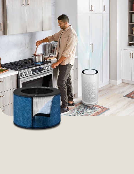 LG air purifier with a cooking filter running in the background as a man cooks in the kitchen.