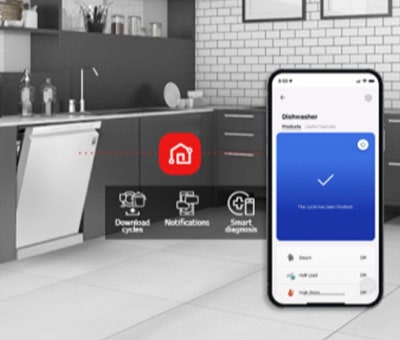 Kitchen interior with partially open free-standing dishwasher and LG ThinQ? app showing cycle complete notification.