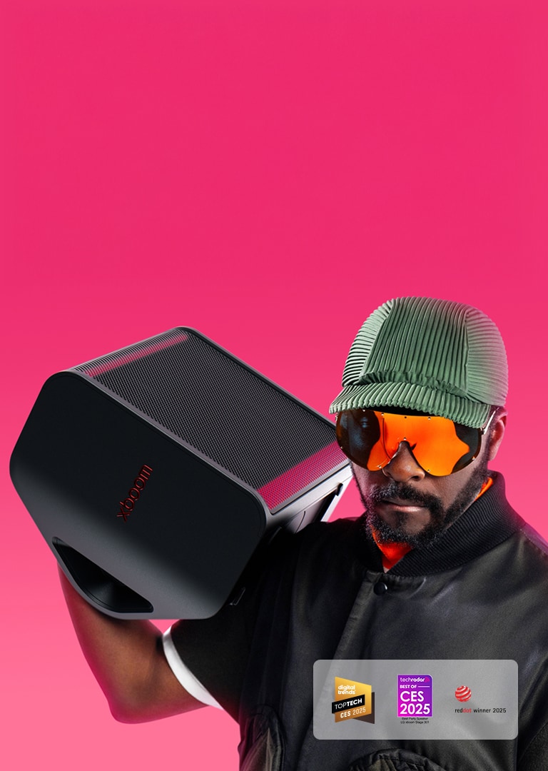 will.i.am in black oufit is holding xboom Stage 301 above his right shoulder.