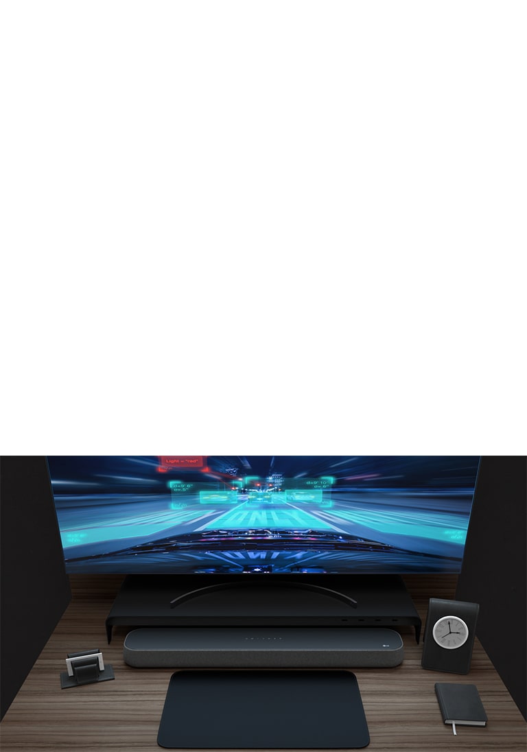A Soundbar , a curved monitor, a note, a small clock are placed on a wooden desk. A racing game is being played on the monitor to describe its game friendly features.