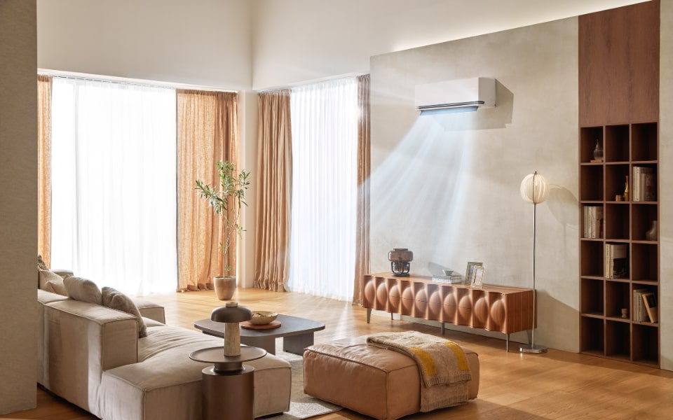 Modern living room with wall-mounted LG AC unit blowing cool air in a bright, stylish interior.