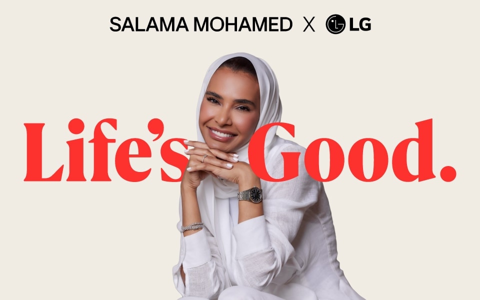 Salama Mohamed partners with LG, smiling confidently beside the bold red slogan “Life’s Good” on a light background. 