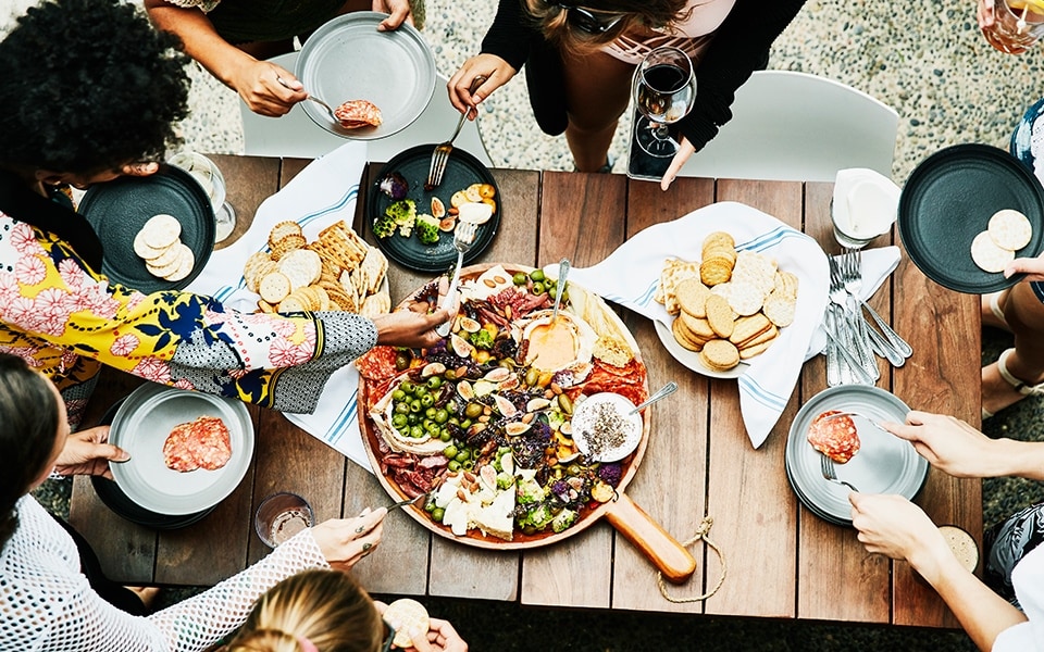 Les amis profitent d'un repas de fête avant de conserver les aliments au réfrigérateur.