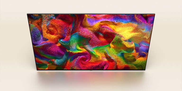 Partículas de cor est?o explodindo na tela e, em seguida, os pixels lentamente se transformam em um close de uma parede pintada com um padr?o colorido na tela da LG TV.