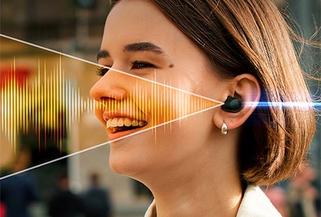 De gauche à droite?: Une femme parle au téléphone à l’extérieur et porte les écouteurs?T80S. Ils filtrent les bruits de fond et l’autre femme ne peut entendre clairement que sa voix.