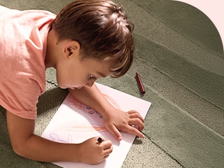 Ni?os escribiendo tarjetas para su mamá y lavando, junto a su papá, la ropa manchada de crayones usando el LG WashTower.