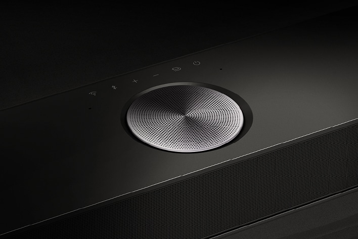 Close-up of one of the speakers on an LG Soundbar. The Soundbar controls are seen above the speaker. 	