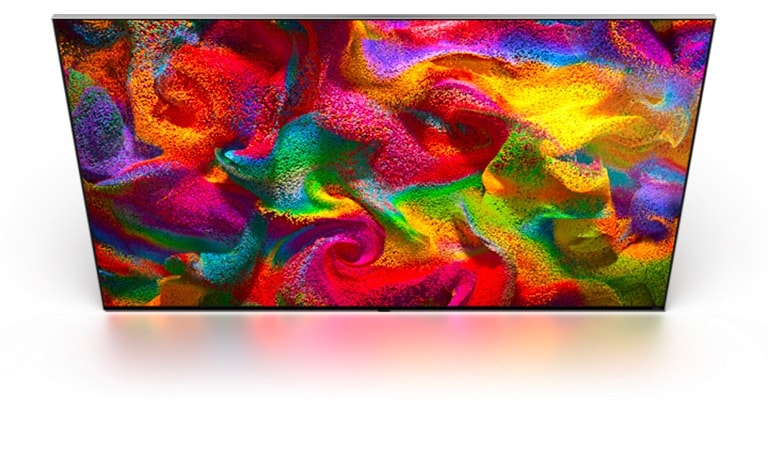 Multi-colored sand explodes in all directions, forming a swirling pattern, then appears as the display of an LG TV.	