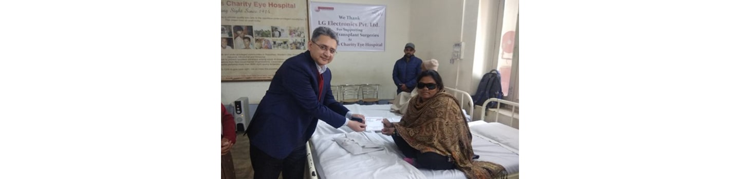 A man hands a patient a document at Dr. Shroff’s Charity Eye Hospital