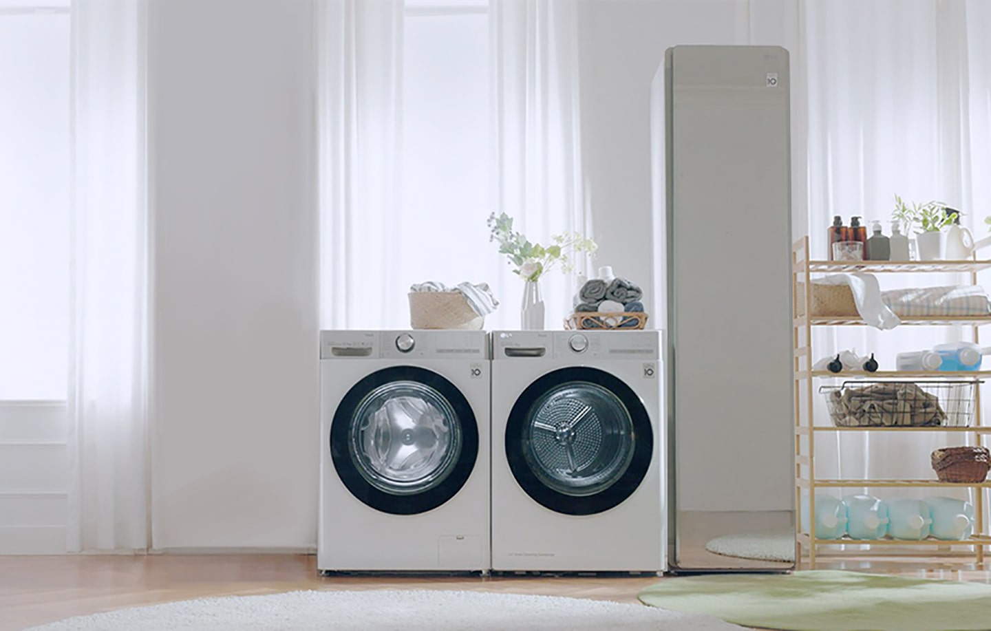 LG washing machine and dryer in a bright expansive utility room next to LG Styler.