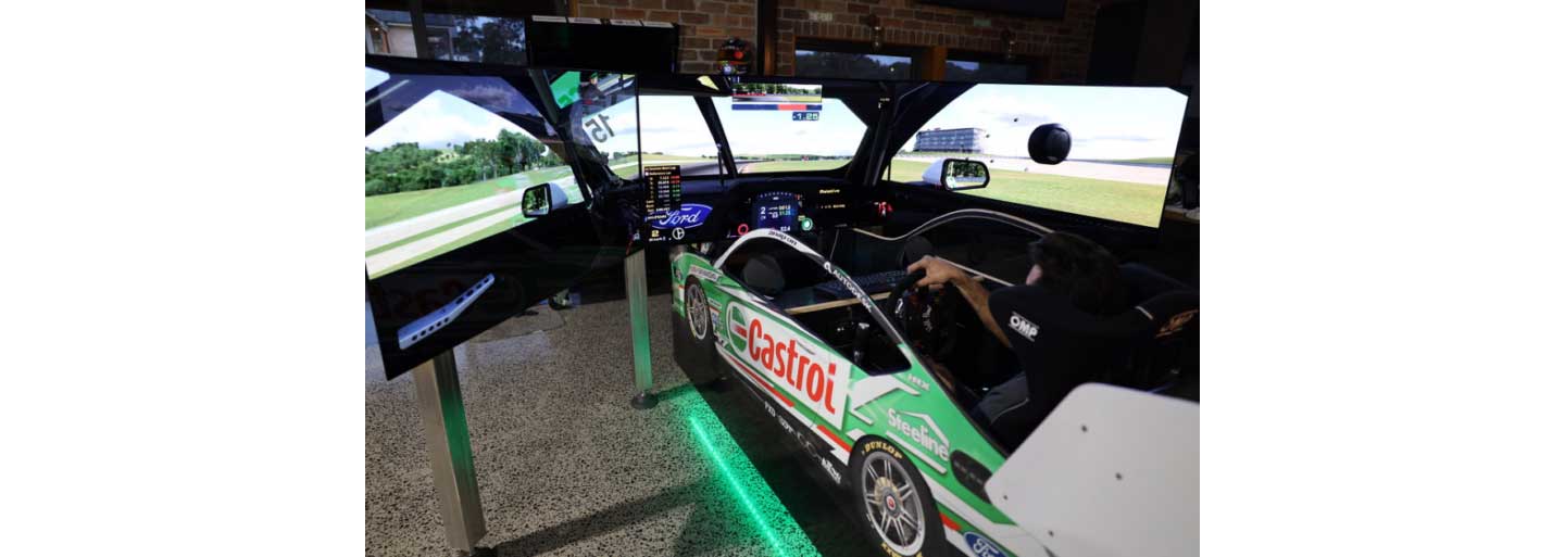 A complete view from the back of someone using the immersive racing simulator