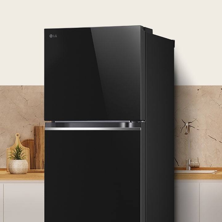 LG top freezer refrigerator in glass panel finish is in modern kitchen, showcasing overall design of the refrigerator.