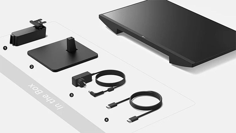 állványtest, állványtalapzat, adapter + tápkábel és HDMI-kábel a dobozban.