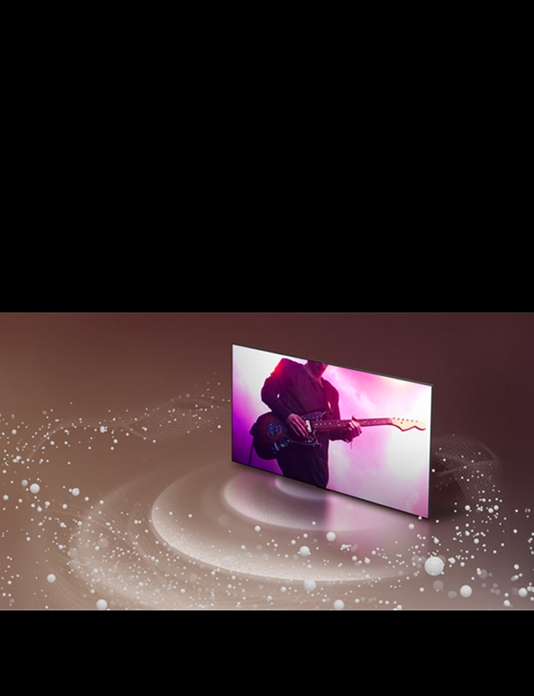 Egy LG OLED TV, amely egy gitárel?adást jelenít meg, halványlila háttér el?tt lebeg. Fehér hanggy?ngy?k és hullámok vetülnek ki a tévéb?l, és k?r?znek k?rül?tte. 