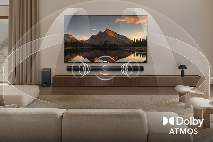 Living room with an OLED LG TV with LG Soundbar. Graphics from the TV screen and speaker show how Dolby Atmos fills the whole space with surround sound from all directions. Dolby Atmos logo is at the bottom corner.	