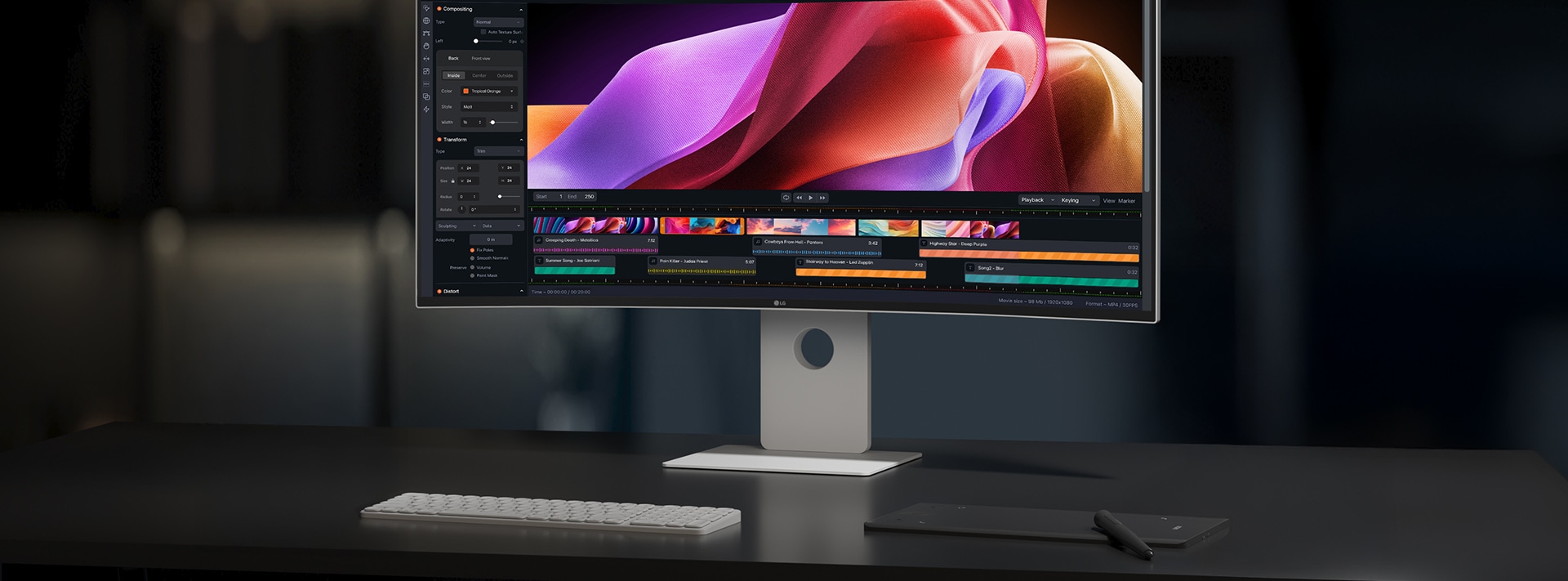 デスク上に、UltraFine?がキーボードとパッドとともに置いてある。畫面には動畫作成プログラムが映し出されている。