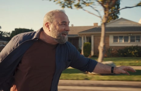 A man skateboarding with a happy expression, demonstrating the power of optimism.