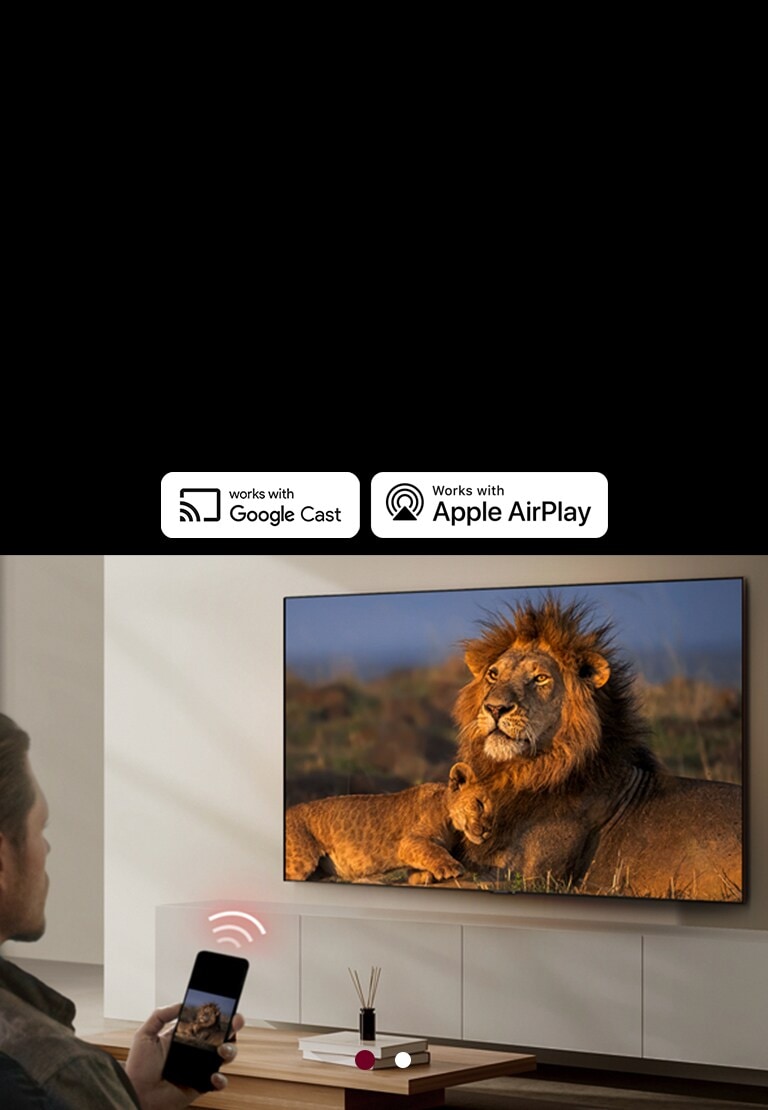 Een LG TV gemonteerd op de muur in een huiskamer, met een leeuw en leeuwenwelpje in beeld. Een man zit in de voorgrond met een smartphone in de hand met dezelfde leeuwen in beeld. Er wordt een graphic weergegeven met drie neonrode gebogen balken boven de smartphone, gericht op de TV.