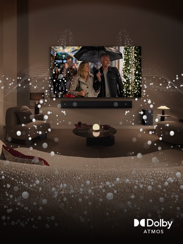 Przytulna, s?abo o?wietlona przestrzeń mieszkalna, LG OLED TV wy?wietlaj?cy par? u?ywaj?c? parasola i jasna okr?g?a grafika otaczaj?ca pokój. Logo Dolby Atoms w lewym dolnym rogu.