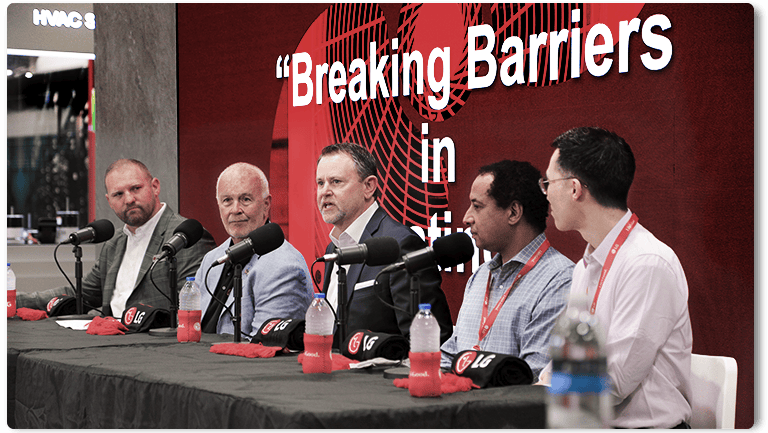 Breaking Barriers panel at a conference discussing business and technology, featuring industry professionals.