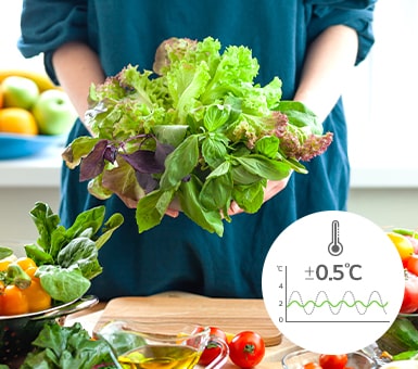 An open LG fridge showing organised contents on the left, fresh vegetables held by a person on the right.