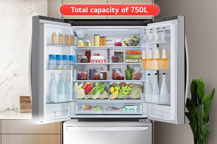 In the kitchen with a sink, there is an open refrigerator with a top door overlooking refrigerated food