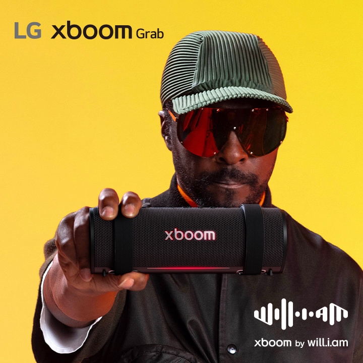 will.i.am in black outfit and sunglasses is holding xboom Grab to the front.