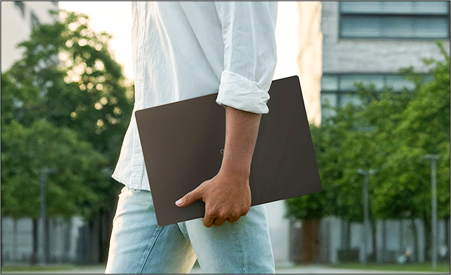 Two photos of a smiling male student carrying and using an LG gram laptop on a university campus.