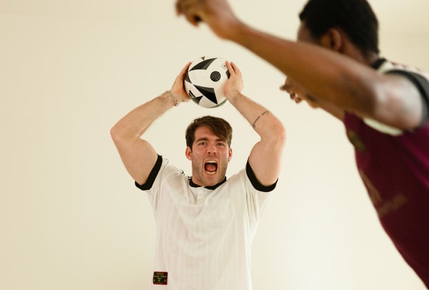Janis Danner plays with a friend with a football ball.