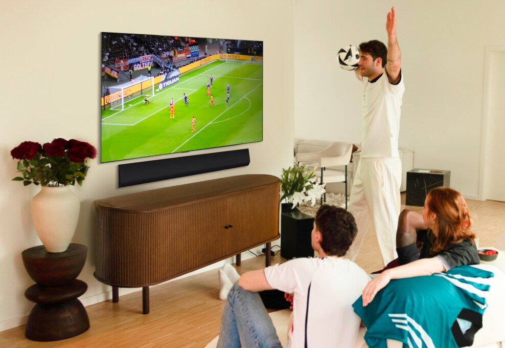 Janis Danner cheers while watching a football game with friends on her LG OLED G4 TV.