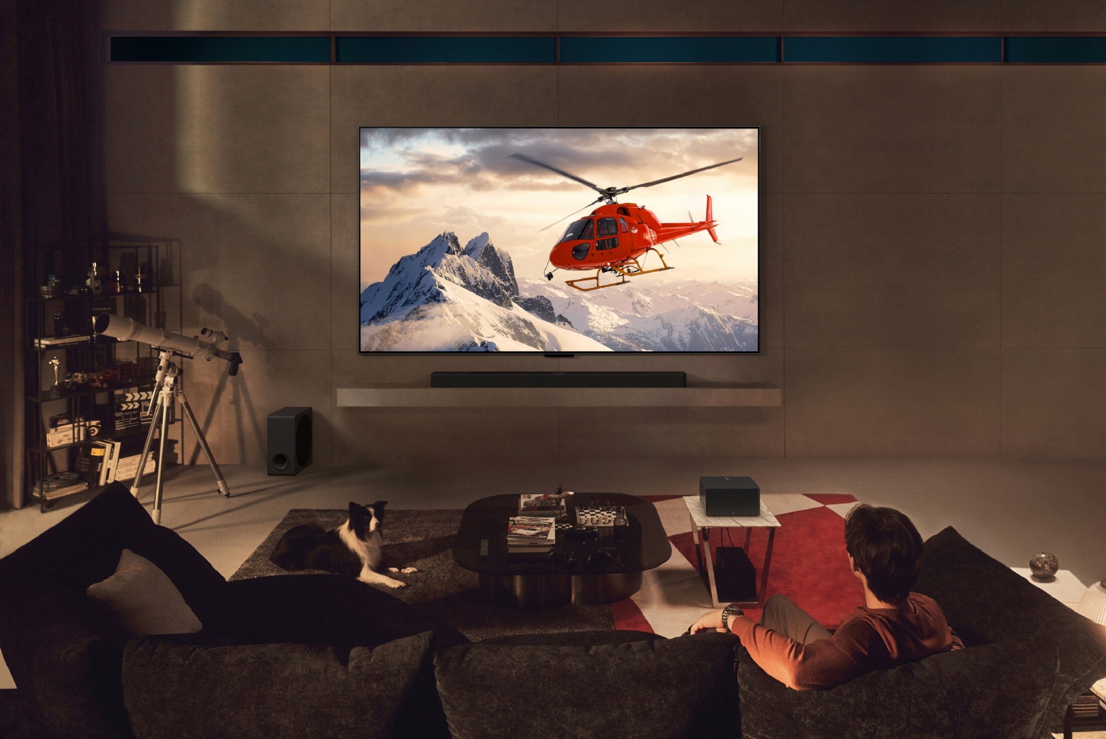 LG OLED TV with a helipcotper on the screen in a dark living room