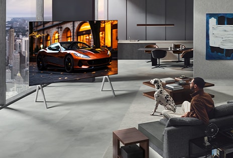 Phòng khách v?i TV LG True Wireless và LG Soundbar treo t??ng. H?p k?t n?i kh?ng day h?u nh? v? hình bên d??i bàn ph? c?nh gh? dài, cho th?y kh? n?ng ??t d? dàng ? b?t c? ?au. B? c?c c?a toàn b? phòng khách g?n gàng và ng?n n?p. 