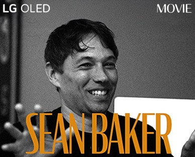 M?t b?c ?nh t?nh ?en tr?ng t? cu?c ph?ng v?n v?i Sean Baker. Tên c?a anh ?y xu?t hi?n b?ng ch? màu cam ??m ? cu?i khung hình. C?m t? LG OLED n?m ? góc trên cùng bên trái và ch? phim ? góc trên cùng bên ph?i.