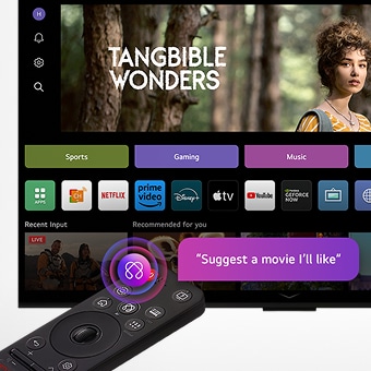 Trên màn hình TV LG OLED là trang ch? webOS 25 v?i ??y ?? các ?ng d?ng và n?i dung gi?i trí. Bên c?nh TV là ?i?u khi?n t? xa LG AI Magic Remote, nút AI ???c làm n?i b?t nh? th? ?? ???c kích ho?t b?ng gi?ng nói c?a ng??i dùng. M?t bong bóng tho?i bên c?nh nó ghi: "G?i y cho t?i m?t b? phim t?i s? thích."