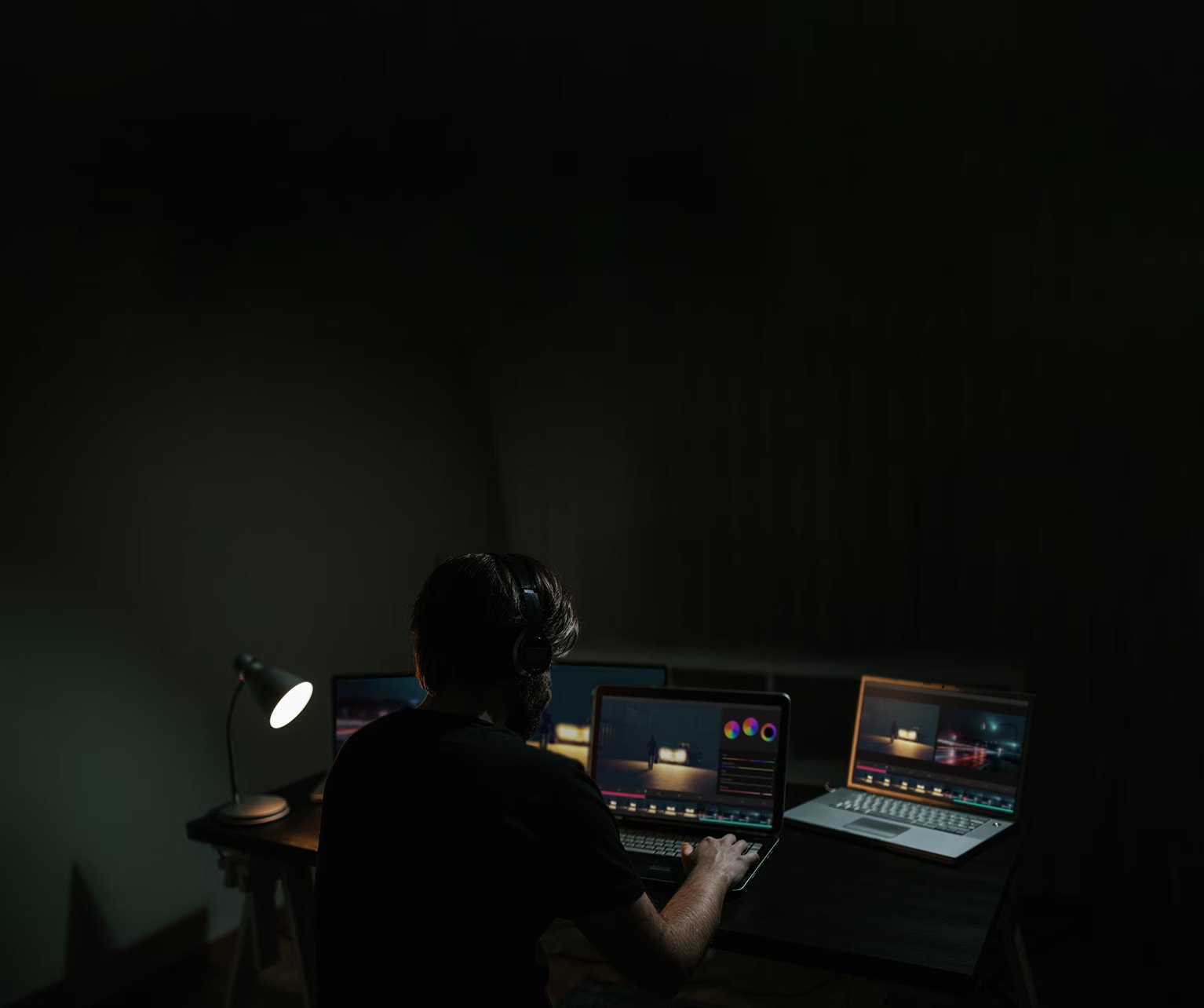 A man edits a movie while looking at the software on a computer monitor