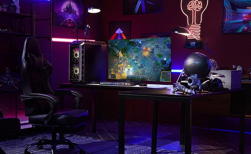 A man plays a game on the smallest LG OLED television while sitting at a desk