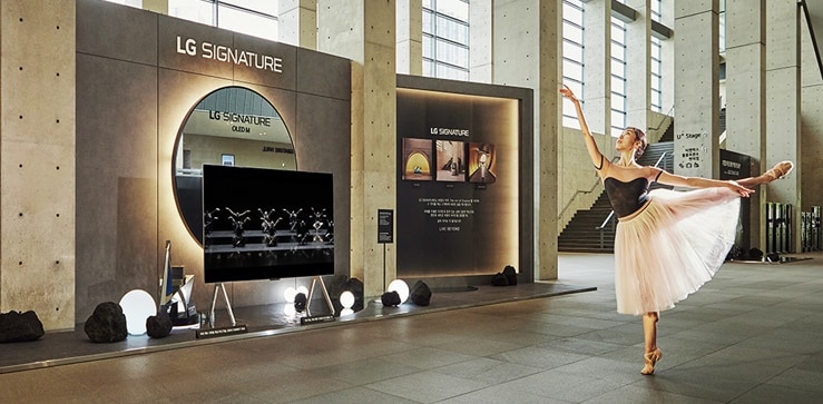 A ballet dancer is seen dancing on the LG Signature TV screen.