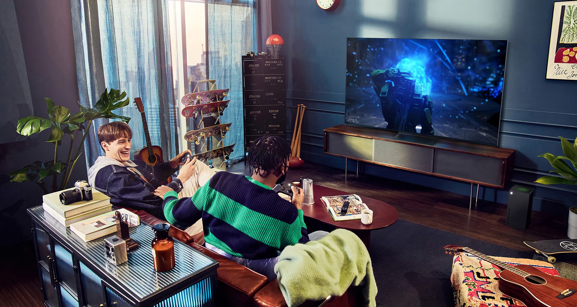 People play a game with a controller on the LG OLED television