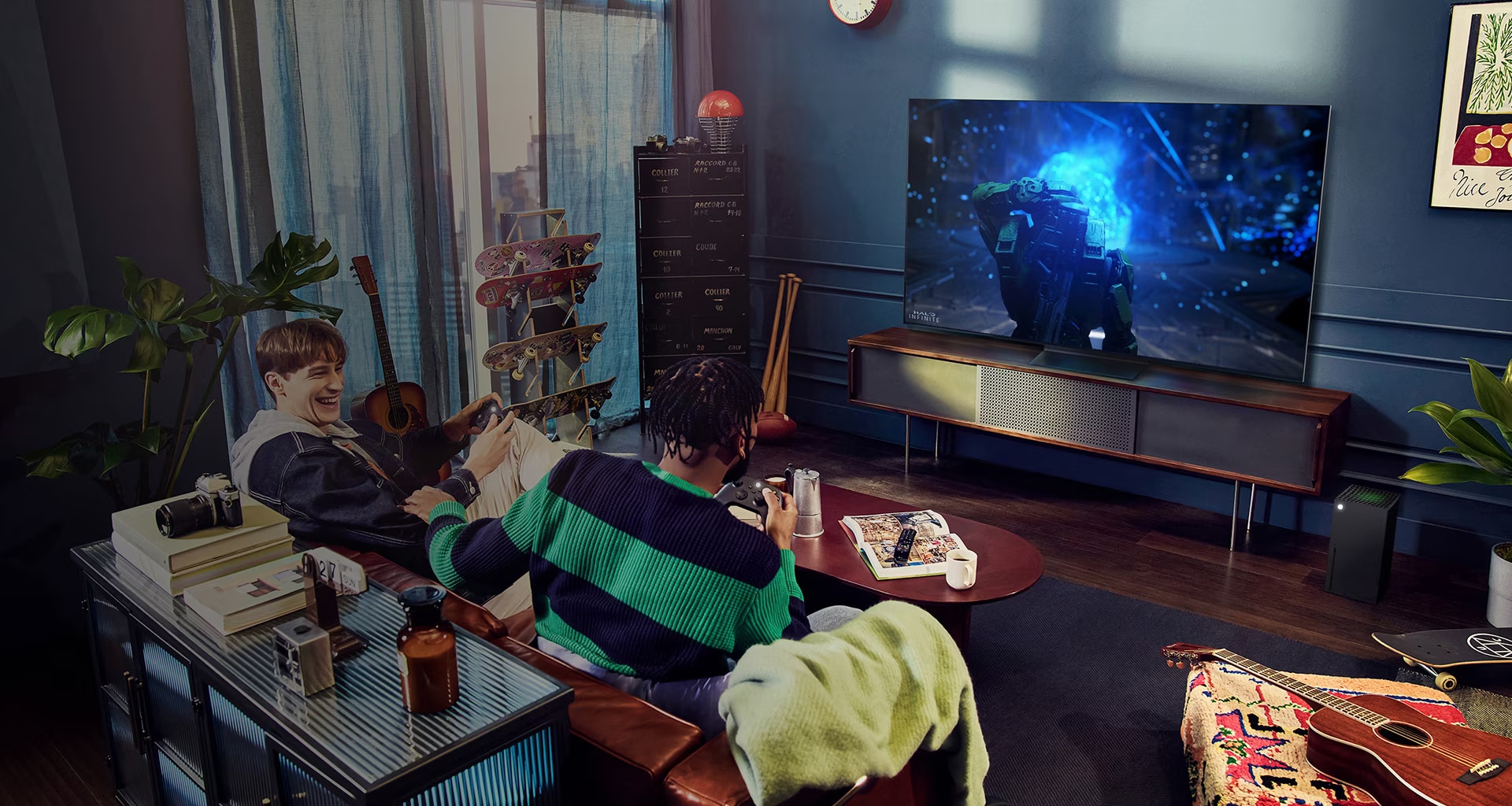 People play a game with a controller on the LG OLED television