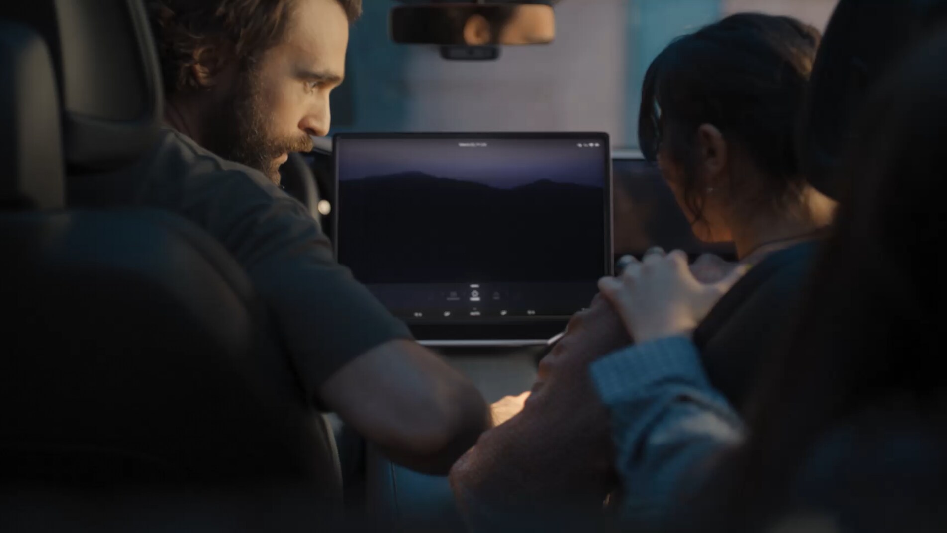 The mother clutches her stomach in pain, her face contorted in discomfort.The family gathers and gets into a car, with LG AI guiding them to the hospital.