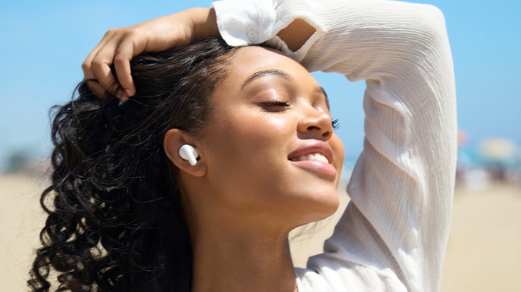 A person is lying in bed sleeping peacefully while wearing T60 earbuds.