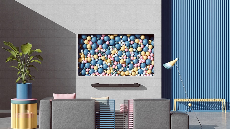 LG SIGNATURE OLED TV, an der Wand angebracht, mit bunten B?llen.