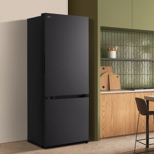 A modern lg black bottom freezer refrigerator with water dispenser is seamlessly fit next to a wooden kitchen countertop.