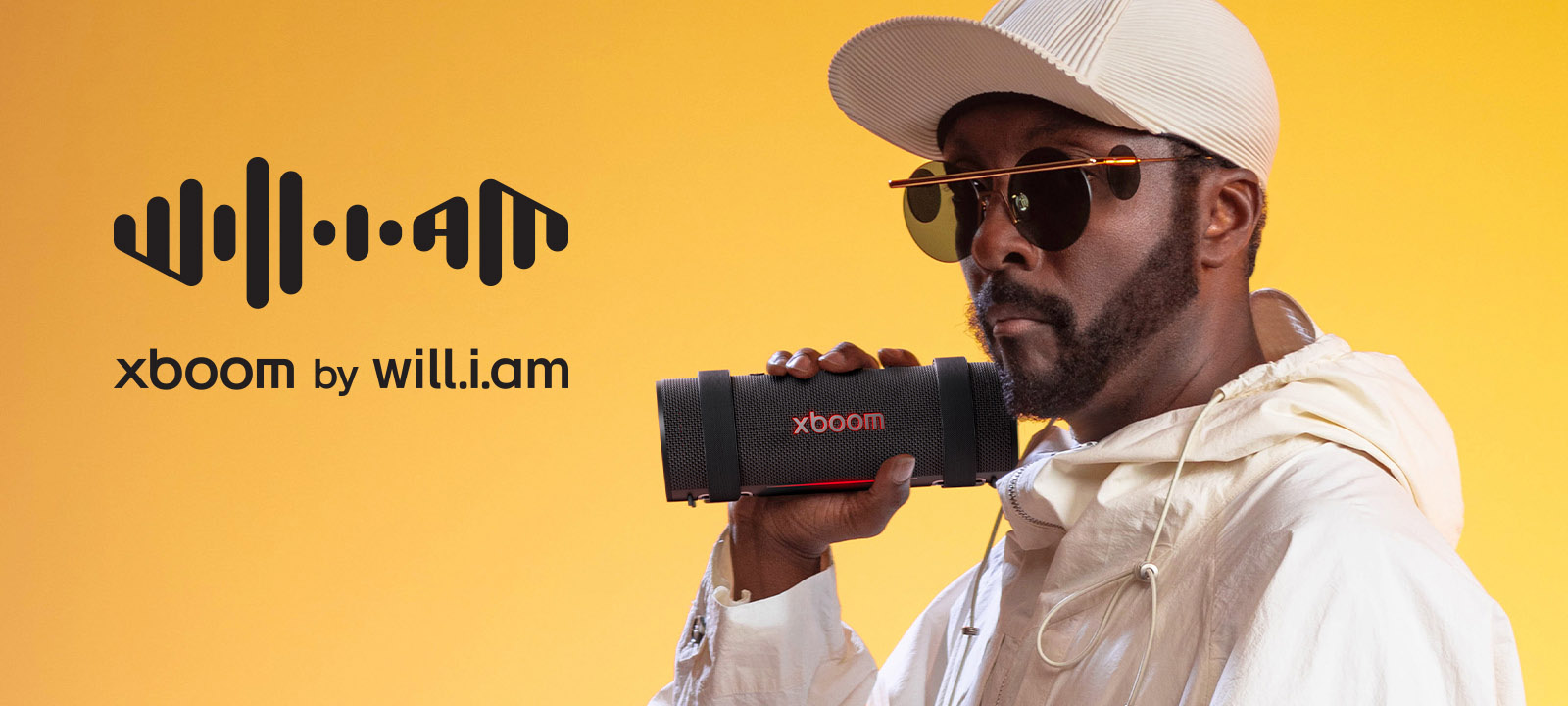 will.i.am in white outfit is holding xboom Grab.	