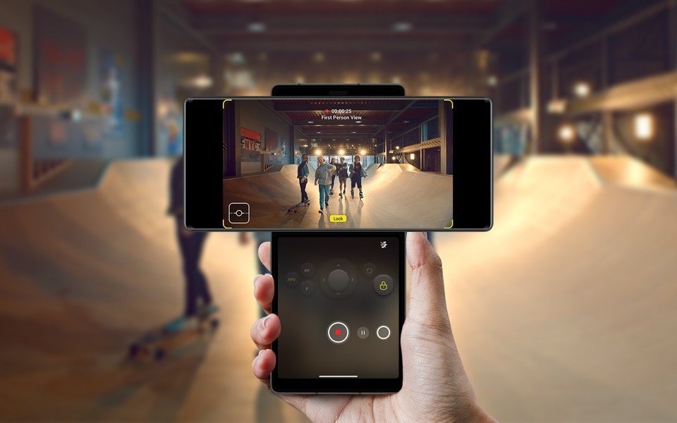 A person using the gimbal motion camera feature on the LG WING to record a group of friends at a skate park