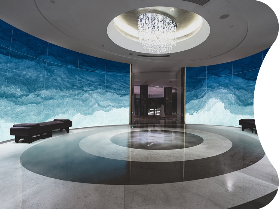 A Flexible Curved Open Frame OLED Signage fills the cruise lobby at a magnificent scale. 