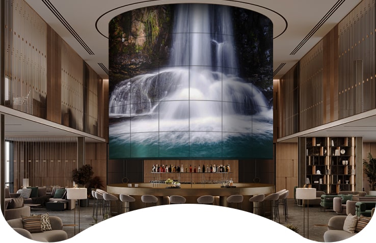 A Flexible Curved Open Frame OLED Signage fills the hotel ballroom at a magnificent scale. 