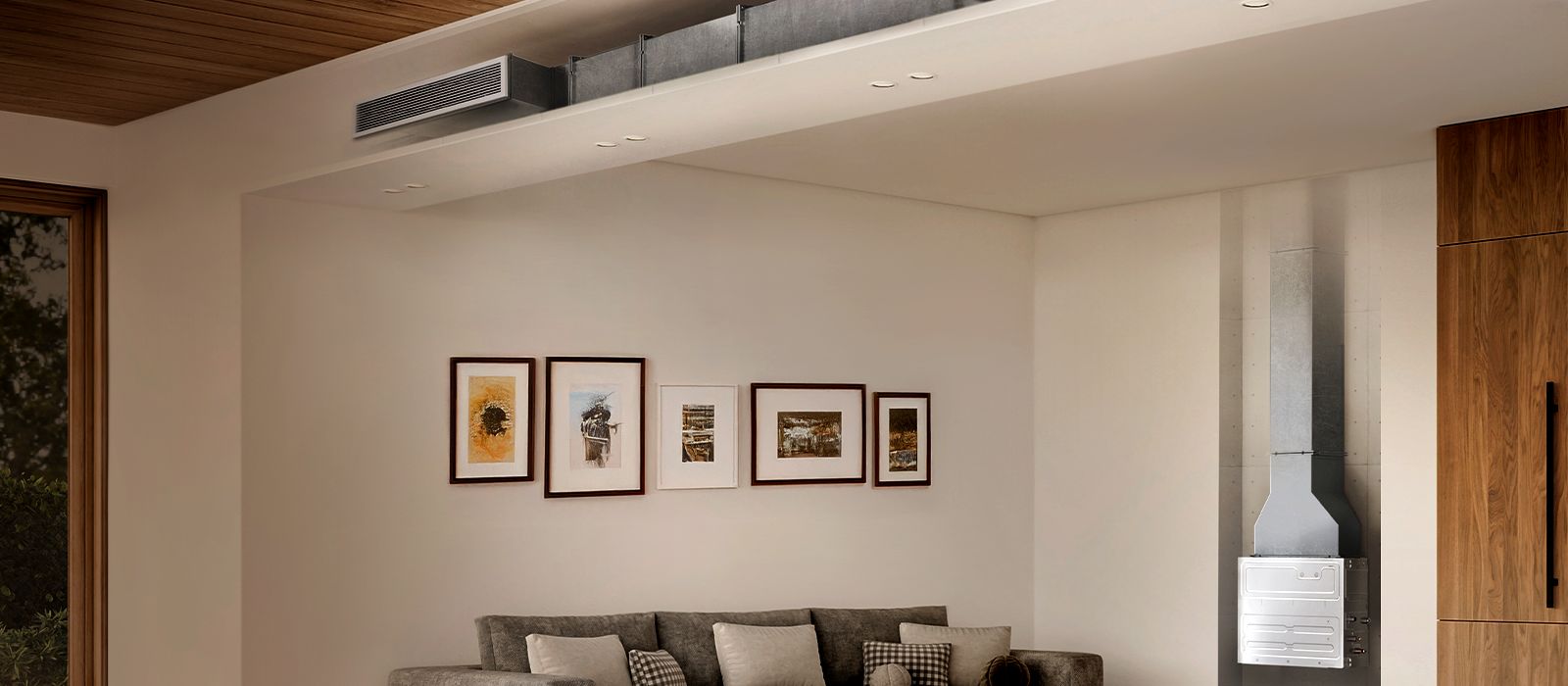 Modern living room with grey sectional sofa, wall art, visible HVAC duct, wood accents, and window view of greenery.