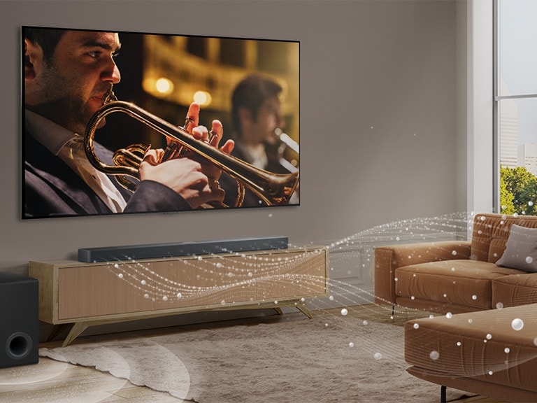  LG Soundbar,  LG TV i niskofrekventni zvu?nik (subwoofer) u modernom gradskom stanu. LG Soundbar emitira tri zvu?na vala, sa?injena od bijelih kapljica koje lebde du? dna poda. Pored Soundbar-a je niskofrekventni zvu?nik (subwoofer) koji stvara zvu?ni efekt odozdo. 